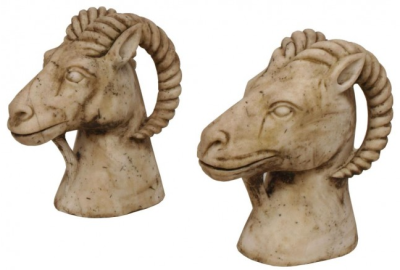 Pair of carved marble rams heads